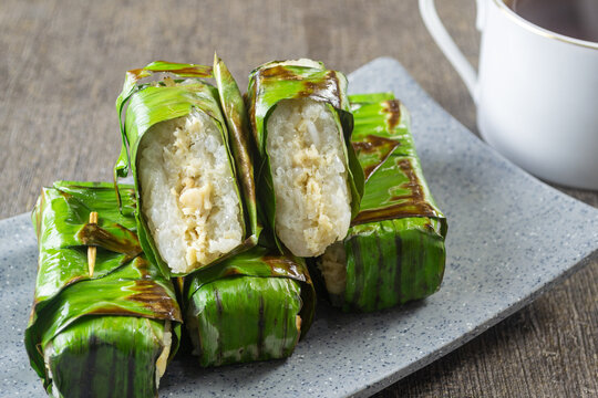 Lemper Ayam bakar, Indonesian Traditional snack of savory steamed glutinous sticky rice filled with seasoned shredded chicken, wrapped and grilled in banana leaves