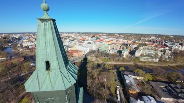 Aerial 4K: Drone Flying Past Turku Cathedral Clock Tower Towards City Center