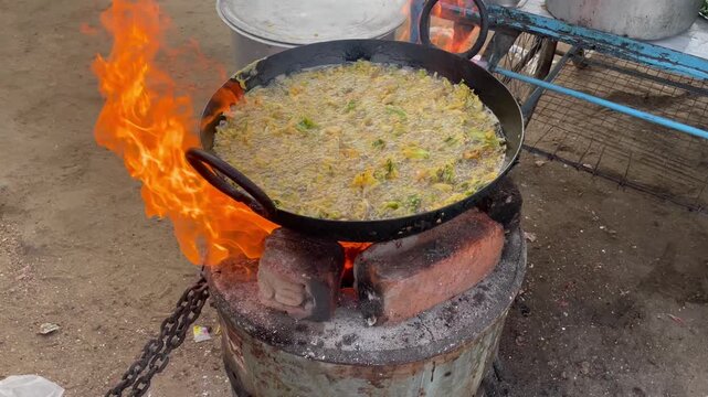 Street Food onion pokoda Cooking in Large Pan Over Open Flame Outdoor Frying