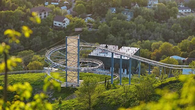 Scenic view of a mountain roller coaster track during golden hour