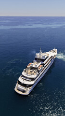 Naklejka premium Aerial drone photo of luxury yacht with wooden deck cruising deep blue Aegean open sea