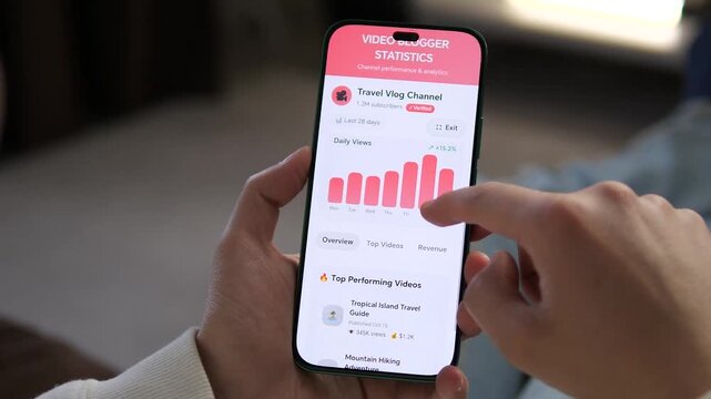 Close-up of scrolling through video blogger statistics on a smartphone. Features channel performance, subscriber growth, and watch time. Ideal for tutorials on social media success, influencer