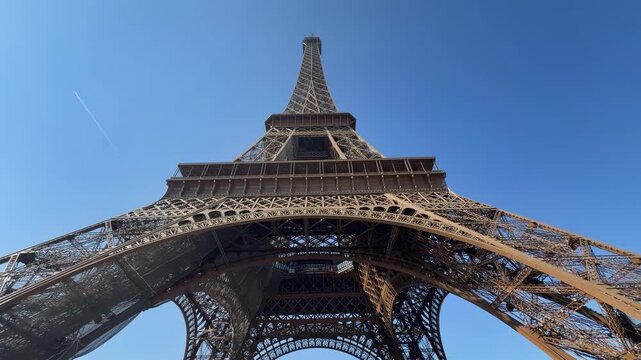 Sunlit framework highlights detailed rivets and majestic height