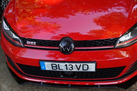 Red Volkswagen Golf GTI front view showing emblem