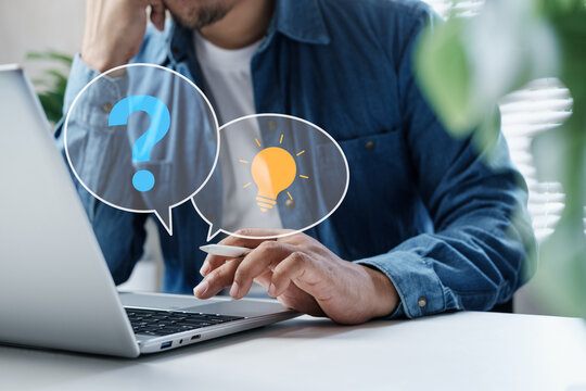 Business professional working on laptop with question and idea icons overlay, representing problem solving, critical thinking, decision making, innovation process, finding solutions modern workplace