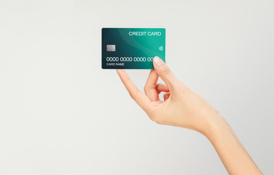 Hand holding mockup credit card isolated on white background, modern design.