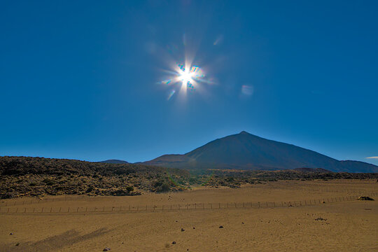 Blue sky with bright sun with rays over Mount Teide in Tenerife, Canary islands, Spain 