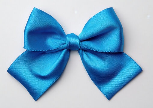 Bright blue bow made of shiny fabric placed on a plain background for crafting or decoration ideas