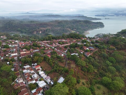 This is an aerial of Suchitoto, with Lago Suchitl&aacute;n in the background. From sacred streets to untamed landscapes, this is El Salvador. Traditional central American homes feature in this wide shot