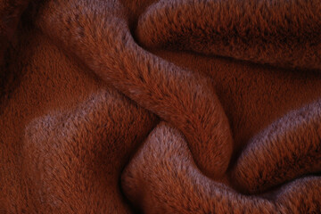 Luxurious red faux fur texture background with smooth waves © Alina 