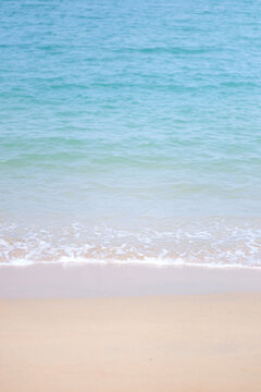 Vertical landscape image of white beach and sea wave