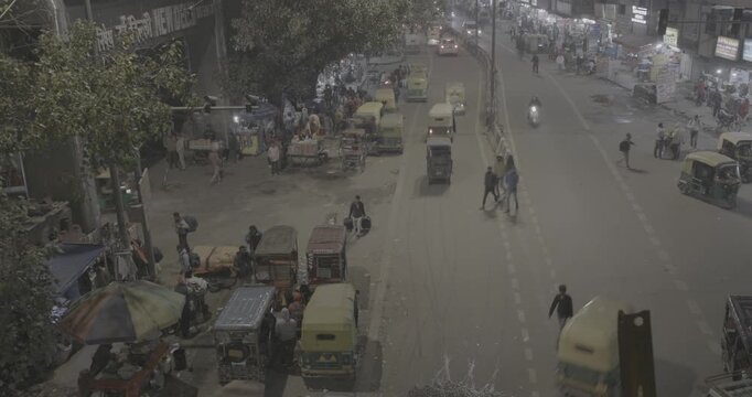 New Delhi, Delhi, India. Traffic On The Main Bazar road Street Paharganj. Cars, Motorcycles, Auto Rickshaw Or Tuk-tuk Moving On Street In night time. nighttime timelapse time lapse time-lapse