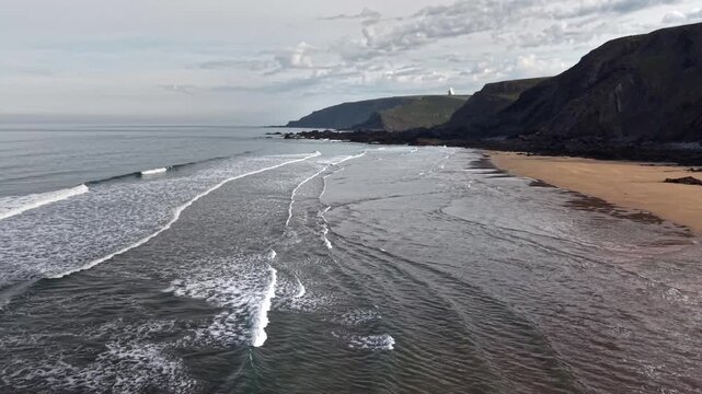 Gentle surf at Sandymouth Bay drone view