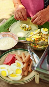Indonesian woman making traditional Selat Solo roll