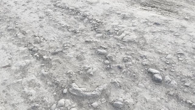 Unpaved Rural Road with Rough Muddy Texture