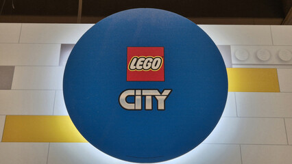 Naklejka premium A circular blue LEGO City sign displaying the red brand logo above the silver and white City series wordmark. Picture taken on April 27, 2026 in Bucharest, Romania.