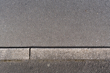 Fototapeta premium paved road surface and concrete curb