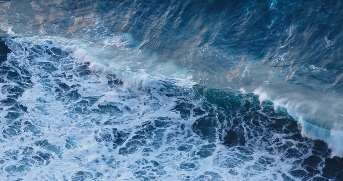 Aerial Top View of Deep Turquoise Ocean Water Texture with White Foam and rolling and crashing waves nature video