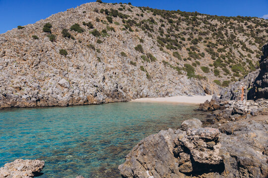 Cala Domestica beach in Sardinia, Italy, showing blue sea and rocky cliffs, tranquil Mediterranean nature