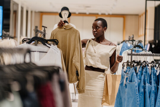 Young Black Shopper Examining Fabric Quality of New Apparel Collection