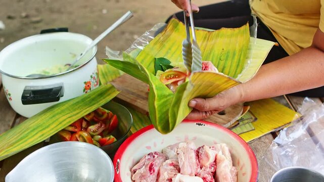 Traditional indonesian food preparation using banana leaves