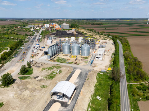 Construction site of a modern agricultural complex with silos, grain elevator and storage terminal. Aerial view