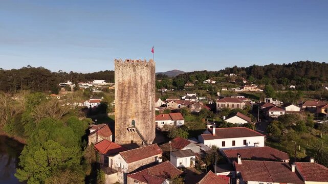 Lapela tower a medieval castle reflecting in the calm waters of minho river