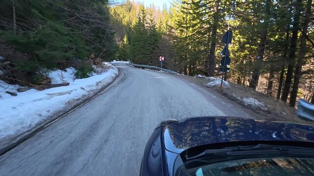 Car ride on a spring day in the Carpathian Mountains, a winding mountain road.