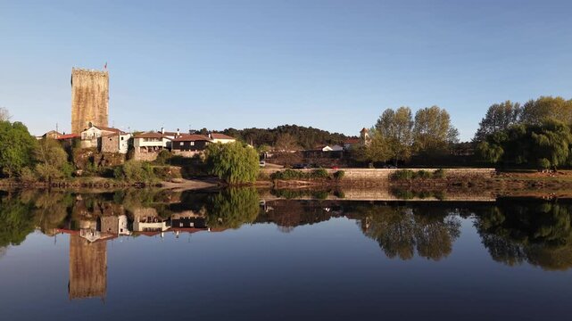 Lapela tower a medieval castle reflecting in the calm waters of minho river