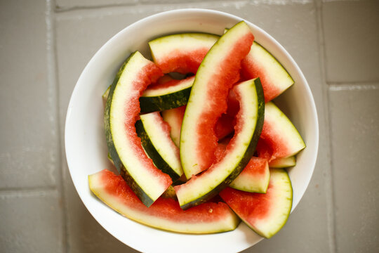 Close up of bowl with fresh watermelon slices, juicy summer fruit, minimal composition and healthy snack concept