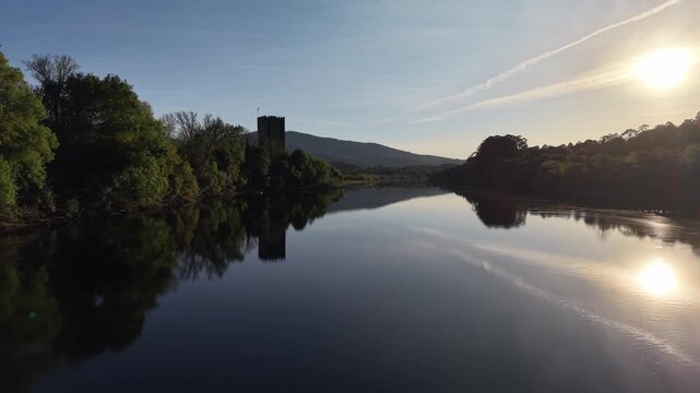 Lapela tower a medieval castle reflecting in the calm waters of minho river