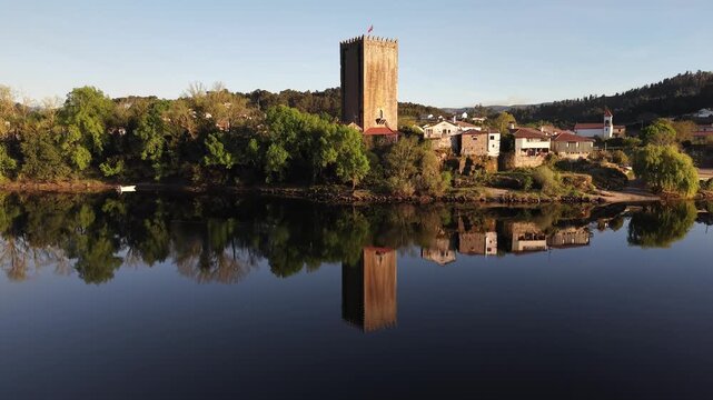 Lapela tower a medieval castle reflecting in the calm waters of minho river