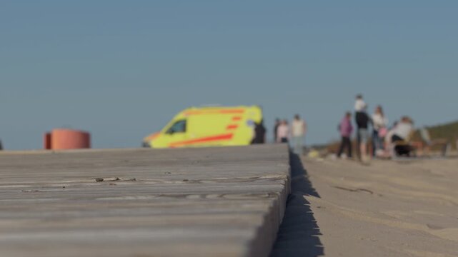 Rescue team scene. Beachside ambulance crew provides urgent medical assistance Outdoors. Rescue personnel offer lifesaving care on sandy coast under bright daylight conditions