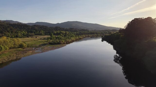 Lapela tower a medieval castle reflecting in the calm waters of minho river