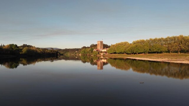 Lapela tower a medieval castle reflecting in the calm waters of minho river