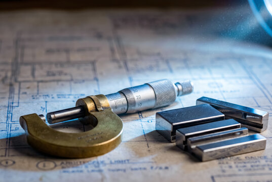 Greeting card base World Metrology Day with micrometer and gauge blocks on technical blueprint.