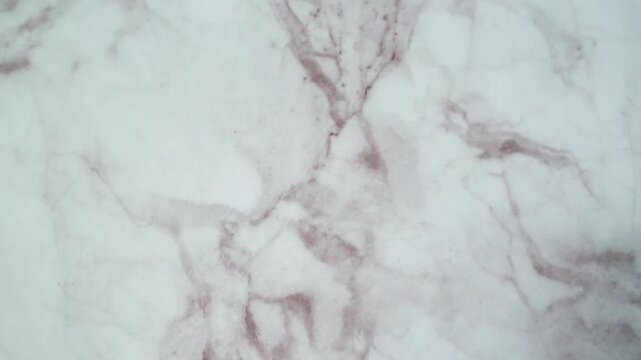 an elegant marble surface texture with a clean white background and fine gray-brown grain lines.
