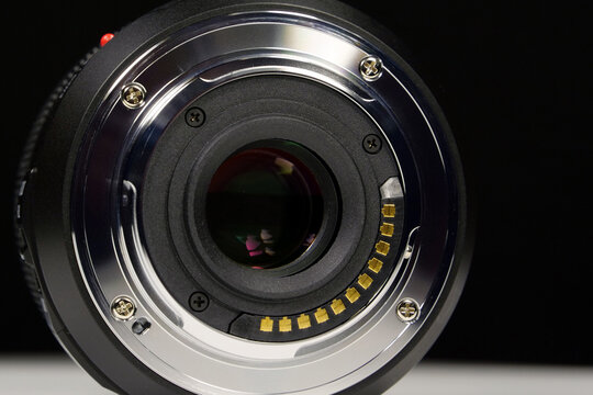 Black background close-up of MFT macro lens mount showing details and texture