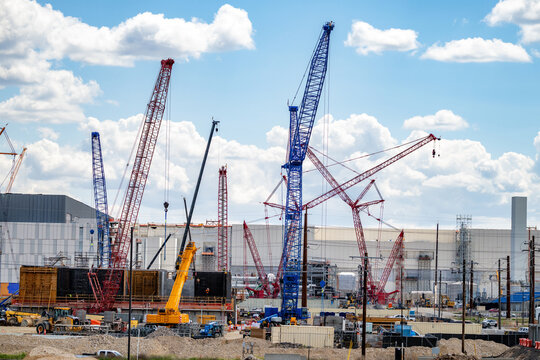 Many cranes erect at a construction site