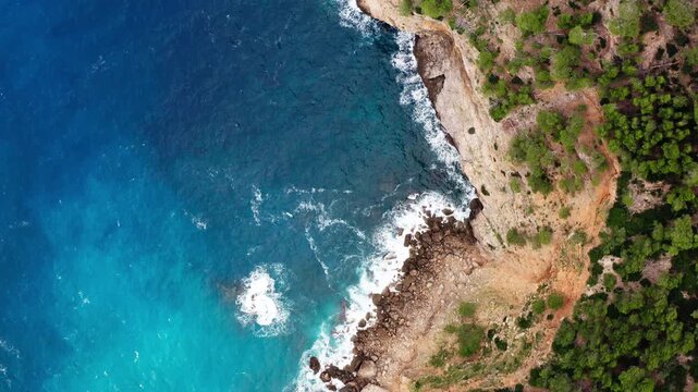 Aerial view of nature landscapes of Mallorca island in Spain. Mediterranean sea waves crashing on rocky shore, travel and tourism in Europe.