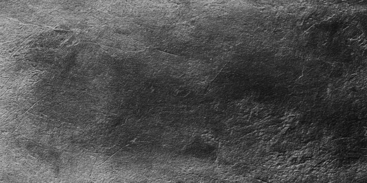 A dark and vintage black fur texture features a rough grunge pattern on a blank material surface to create a dirty grey backdrop