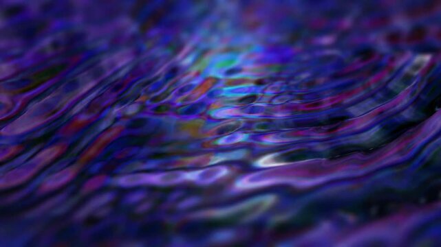 Abstract liquid texture in blue and purple colors with blurred lines and waves.