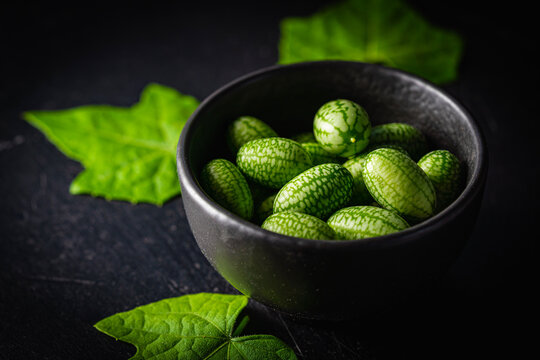 Cucamelon, Melothria scabra in a bowl. organic mouse melon fruits on dark background
