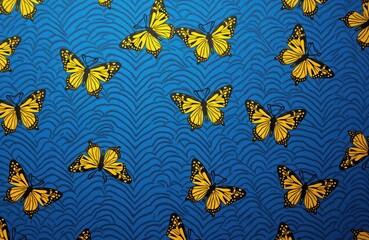Obraz premium Yellow butterflies fly on blue wavy pattern background. Simple insect seamless repeat motif. Nature inspired fabric design for decor apparel.