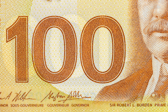 Canada finances. Business concept, economic background. Fragment of a 100 Canadian Dollar note, just the numbers. Close up