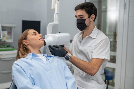 Dentist performing dental x-ray for patient