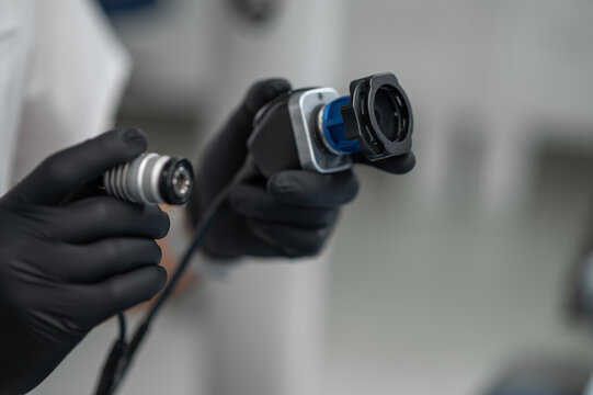 Professional holding intraoral camera closeup