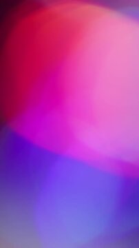Vertical video. Bokeh light. Colorful leak. Purple red green defocused circles flow on dark black background. Spectrum vivid reflection abstract texture.