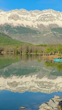 Pristine wilderness background featuring a serene lake and mountain range