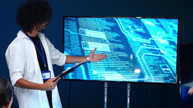 Professional developer presenting complex computer code on a digital screen during a tech meeting in a modern office, showing software programming and data analysis for a corporate project